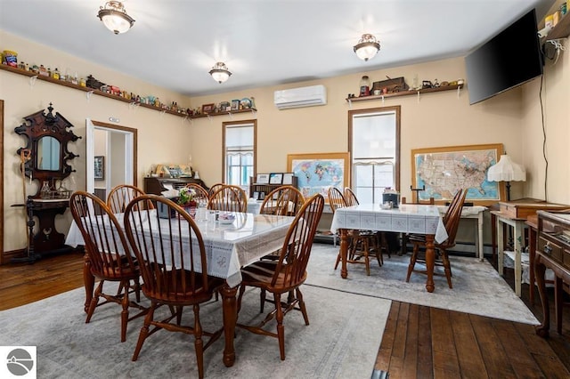 dining room featuring a wall unit AC and hardwood / wood-style flooring