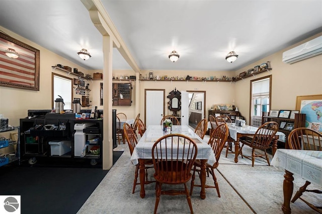 dining room featuring a wealth of natural light, a wall mounted AC, and carpet