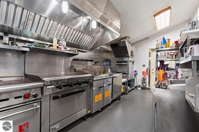 kitchen featuring lofted ceiling, stainless steel counters, island range hood, and stainless steel stove