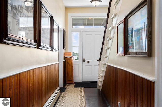 doorway with wooden walls and light hardwood / wood-style floors