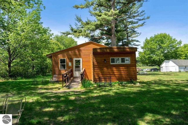 rear view of house with a yard