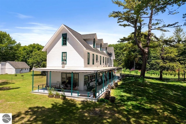 rear view of property with a lawn