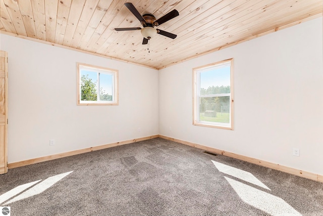 spare room with ceiling fan, wood ceiling, carpet, and crown molding