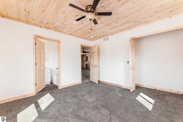 unfurnished bedroom with ensuite bath, wood ceiling, ceiling fan, and carpet