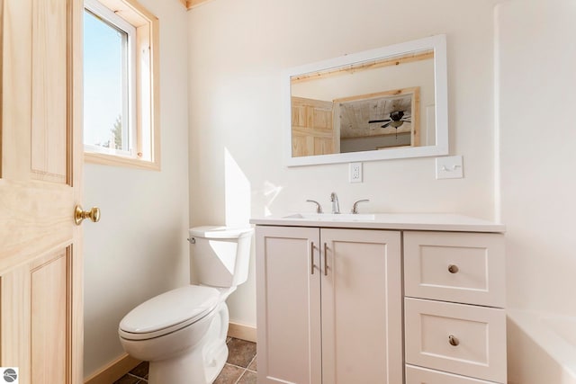 bathroom with a tub to relax in, vanity, toilet, and tile patterned flooring