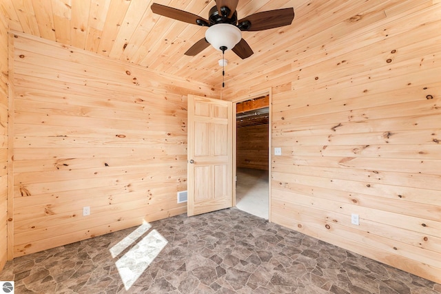 spare room featuring wooden ceiling, wood walls, and ceiling fan