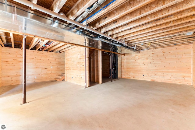 basement featuring wood walls