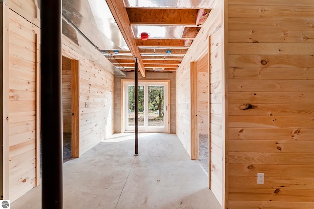 interior space with wood walls and concrete floors