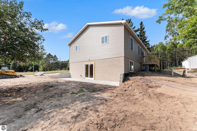 view of property exterior with central AC unit and a deck