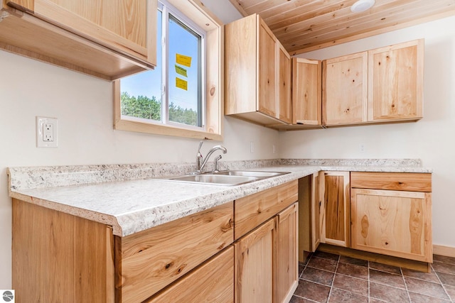 kitchen featuring sink, light brown cabinets, wooden ceiling, and dark tile patterned flooring