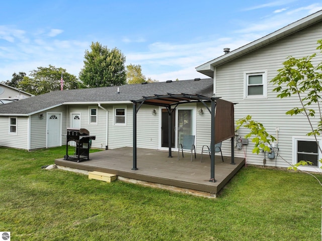 back of house featuring a lawn, a pergola, and a wooden deck