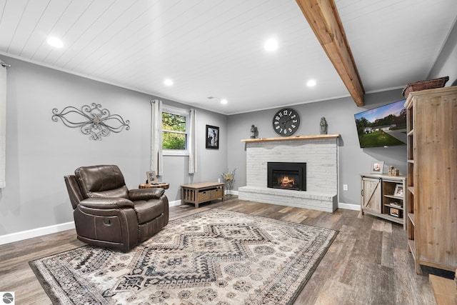 living room featuring wooden ceiling, beamed ceiling, hardwood / wood-style flooring, and a fireplace