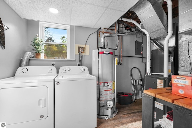 clothes washing area with water heater, washing machine and dryer, electric panel, and hardwood / wood-style flooring