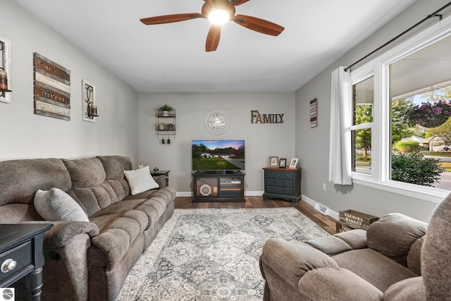 living room featuring ceiling fan and hardwood / wood-style flooring