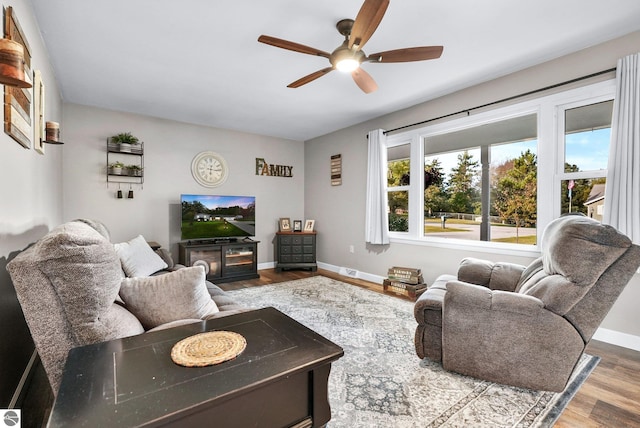 living room featuring ceiling fan and hardwood / wood-style floors