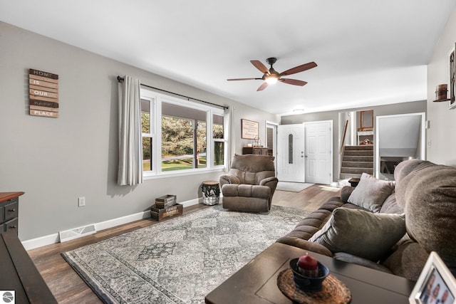 living room featuring wood-type flooring and ceiling fan