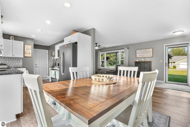 dining area featuring light wood-type flooring and ceiling fan