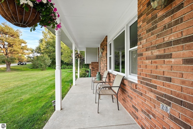 9090 Windsong Ln, Cadillac, MI 49601 - view of patio featuring covered porch