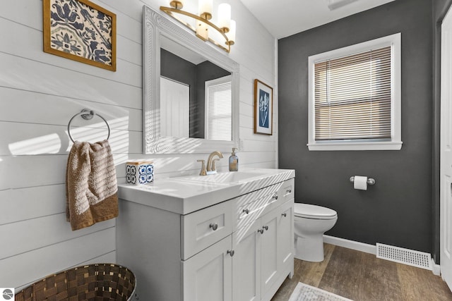 bathroom featuring vanity, toilet, and hardwood / wood-style flooring