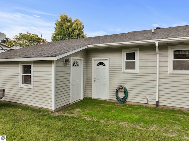 back of property featuring a lawn