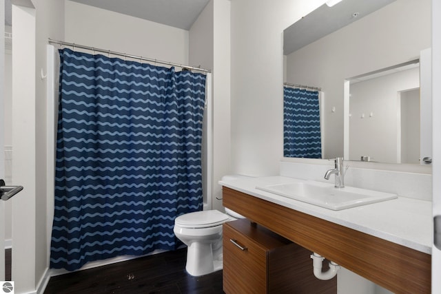 bathroom with hardwood / wood-style floors, toilet, and vanity