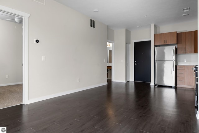 kitchen with dark hardwood / wood-style flooring, stainless steel refrigerator, and ceiling fan