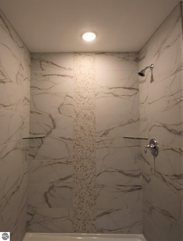 bathroom with a tile shower