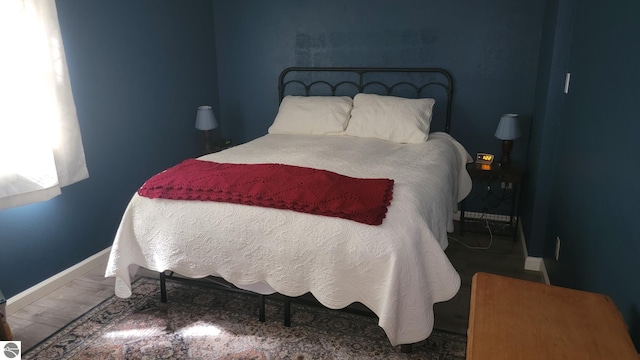 bedroom with hardwood / wood-style floors