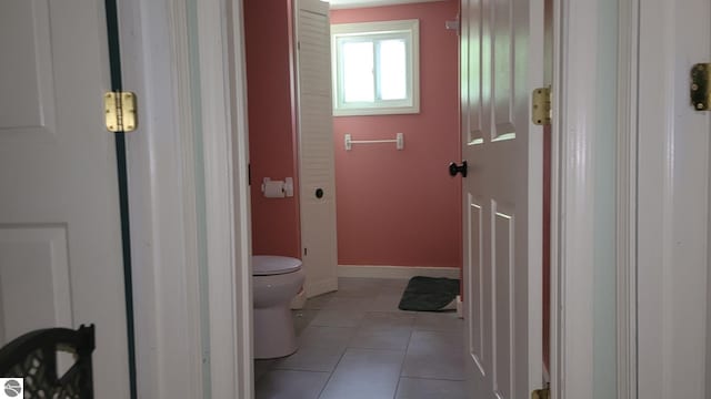 bathroom with toilet and tile patterned floors