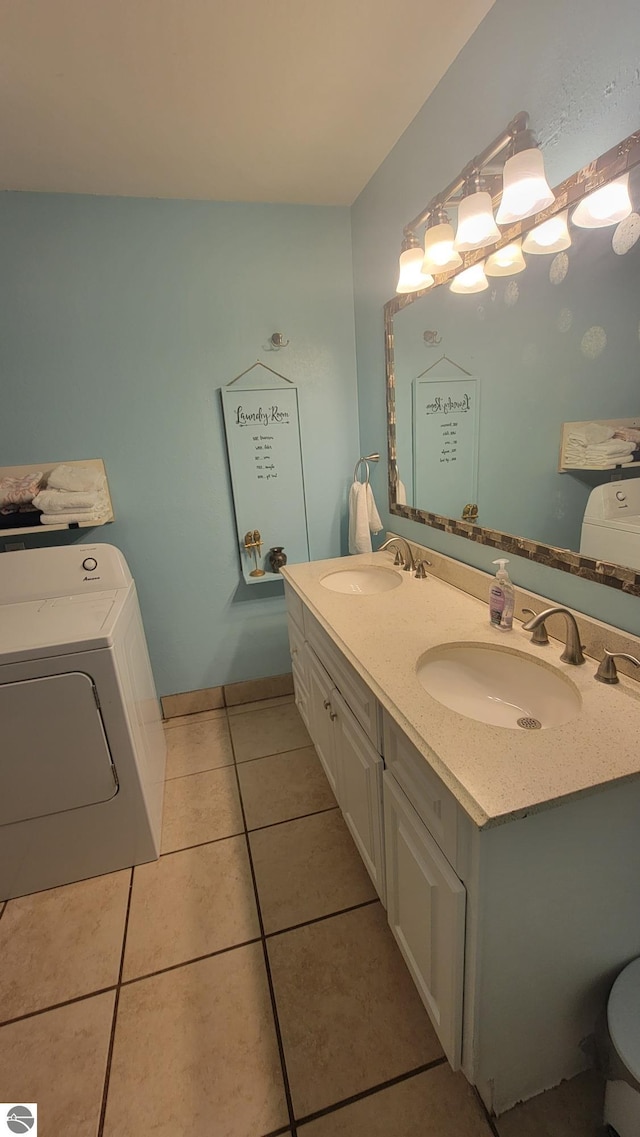 bathroom with washer / dryer, vanity, and tile patterned floors