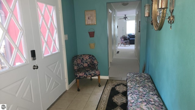 tiled entryway with ceiling fan and a wealth of natural light