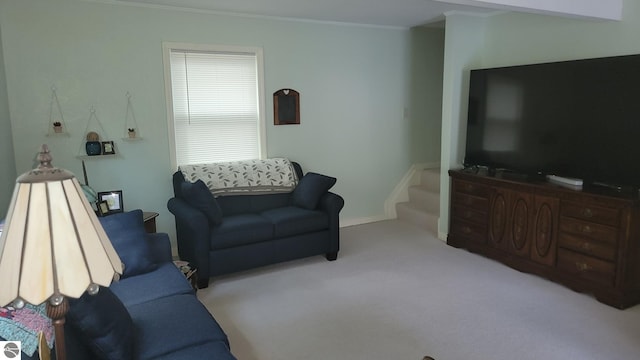 living room featuring ornamental molding and carpet floors