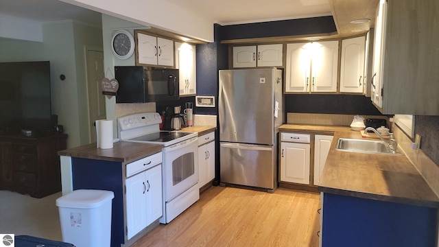 kitchen with light wood-type flooring, stainless steel refrigerator, white cabinetry, sink, and white electric range oven