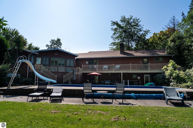 view of pool with a lawn and a patio area