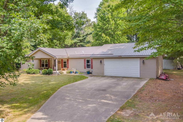 ranch-style home featuring a garage and a front lawn