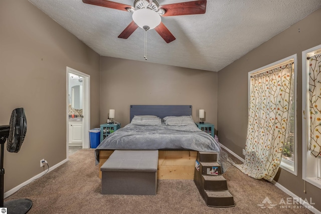 carpeted bedroom with a textured ceiling, ceiling fan, and connected bathroom