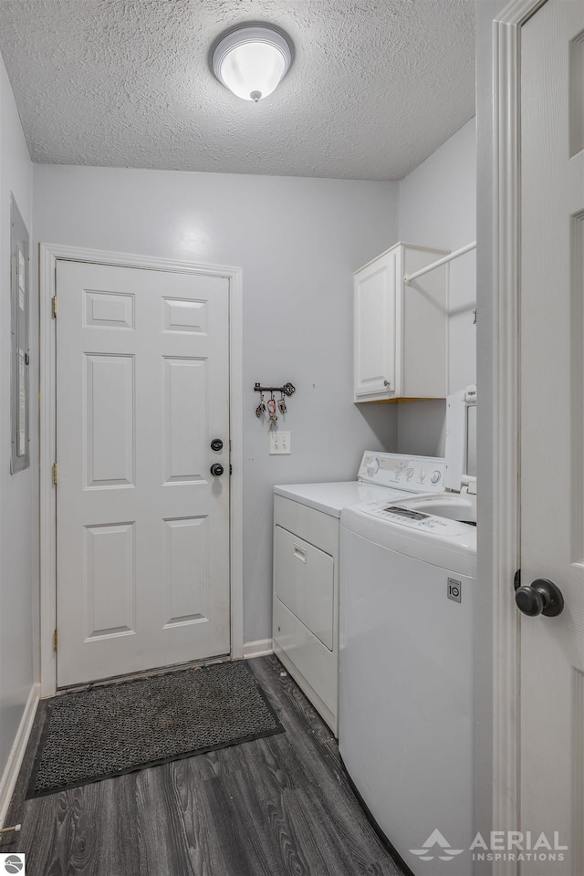 clothes washing area with dark hardwood / wood-style floors, a textured ceiling, cabinets, and separate washer and dryer