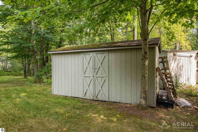 view of outbuilding featuring a lawn