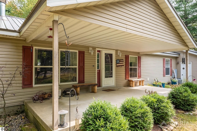 rear view of property featuring a porch