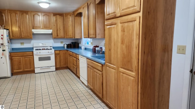 kitchen with light tile patterned floors and white appliances