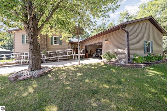 back of property with a yard and a garage