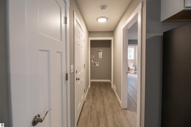 corridor with light hardwood / wood-style floors