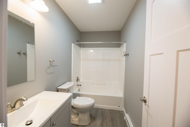 full bathroom featuring vanity, toilet, hardwood / wood-style flooring, and washtub / shower combination