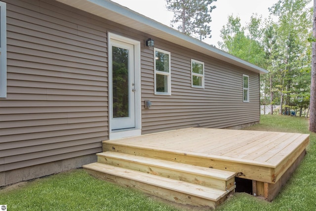 wooden terrace featuring a yard