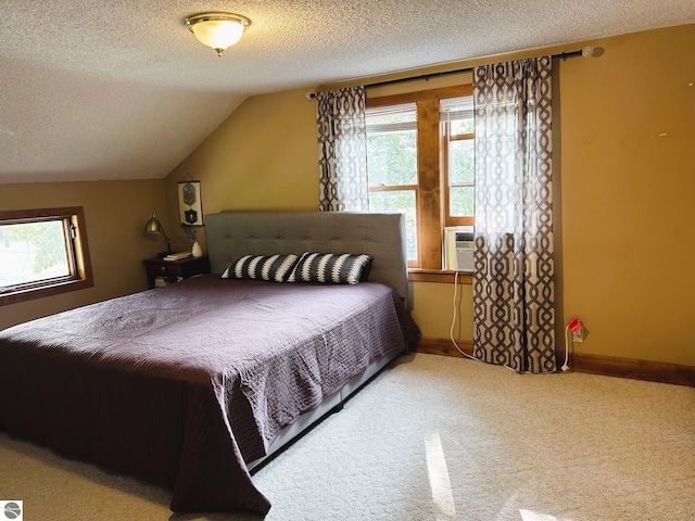 carpeted bedroom featuring cooling unit, a textured ceiling, and vaulted ceiling