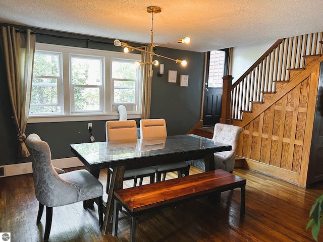 dining area featuring a wealth of natural light, dark hardwood / wood-style floors, and a textured ceiling