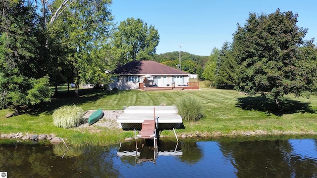 dock area with a deck with water view and a yard