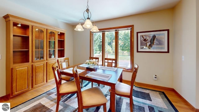 dining room with an inviting chandelier and light hardwood / wood-style floors