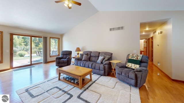 living room with light wood-type flooring, vaulted ceiling, and ceiling fan