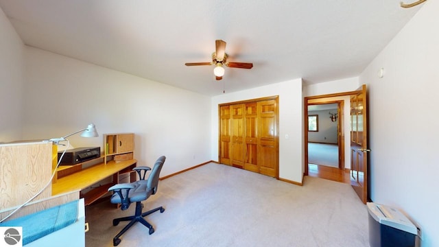 carpeted office space with ceiling fan